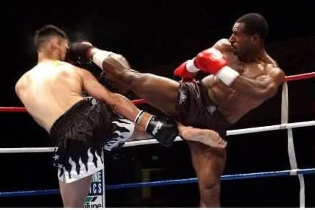 PNG kickboxer landing a high kick during a professional bout