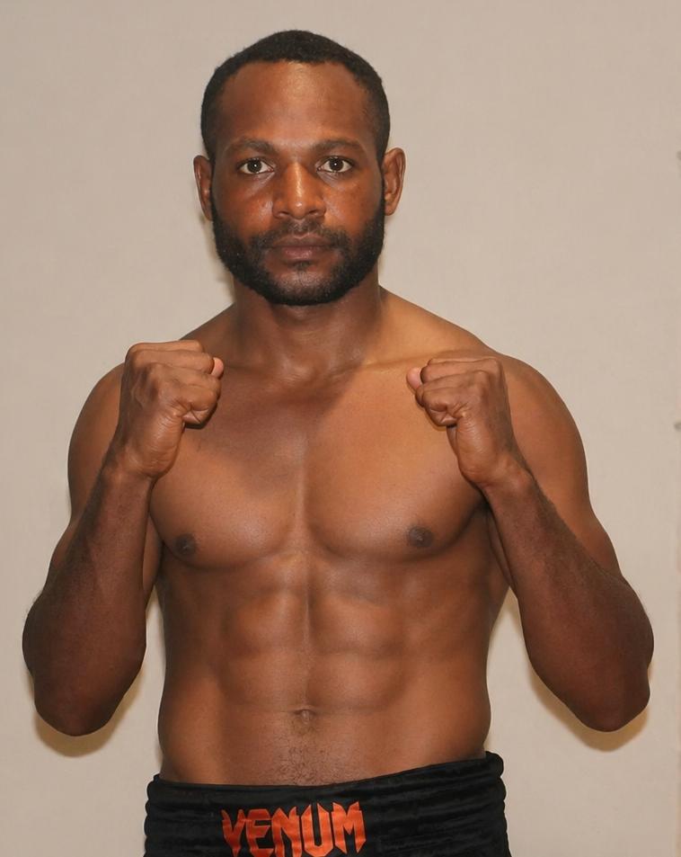 PNG professional fighter in fighting stance wearing Venum shorts