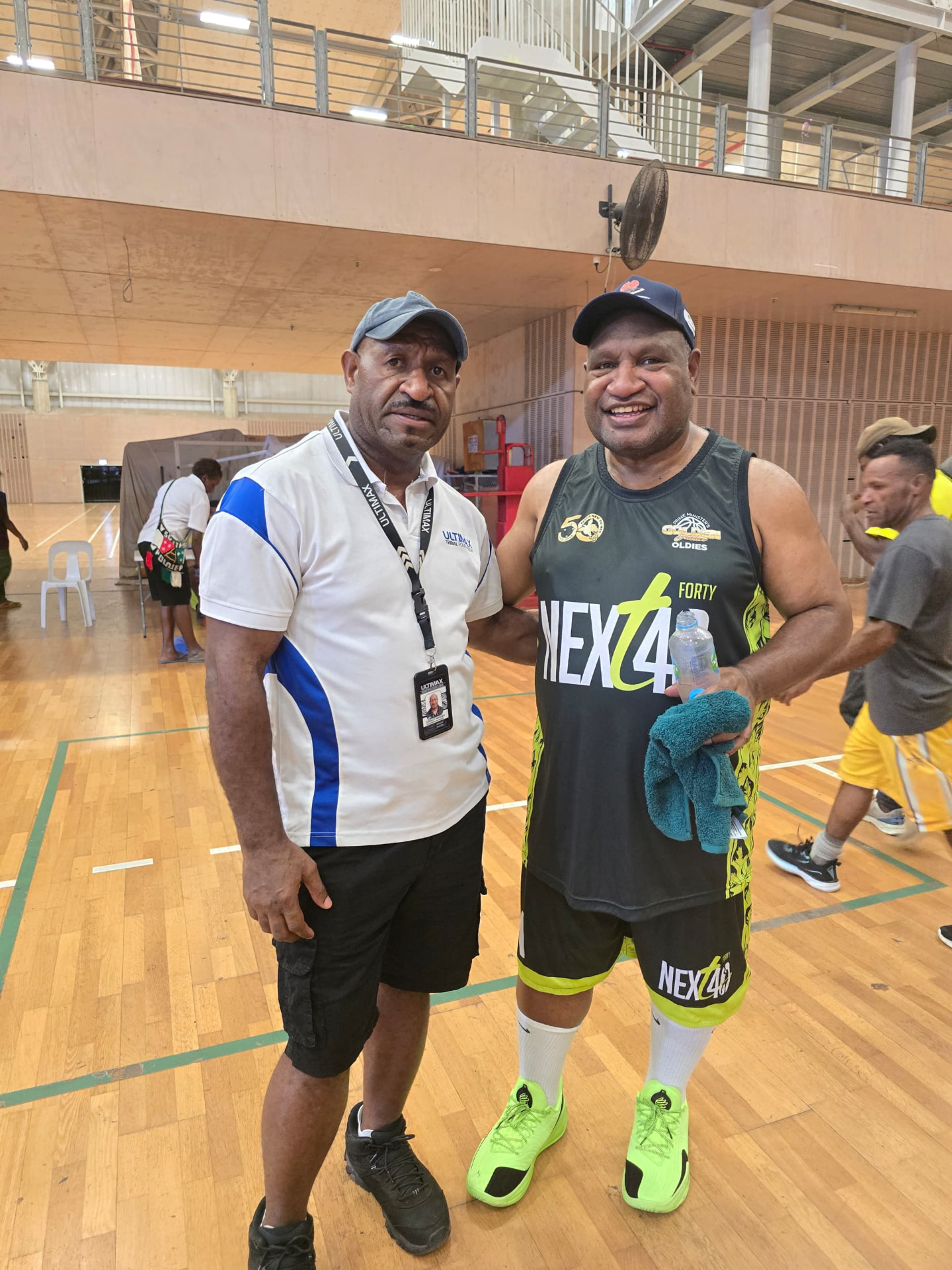 PNGKBF official standing with a supporter at Sir John Guise indoor stadium